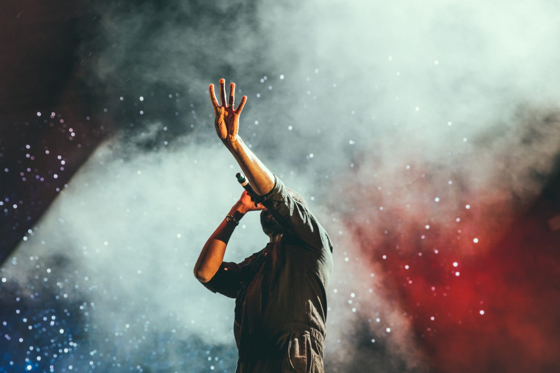 Man singing in concert onstage re music performance